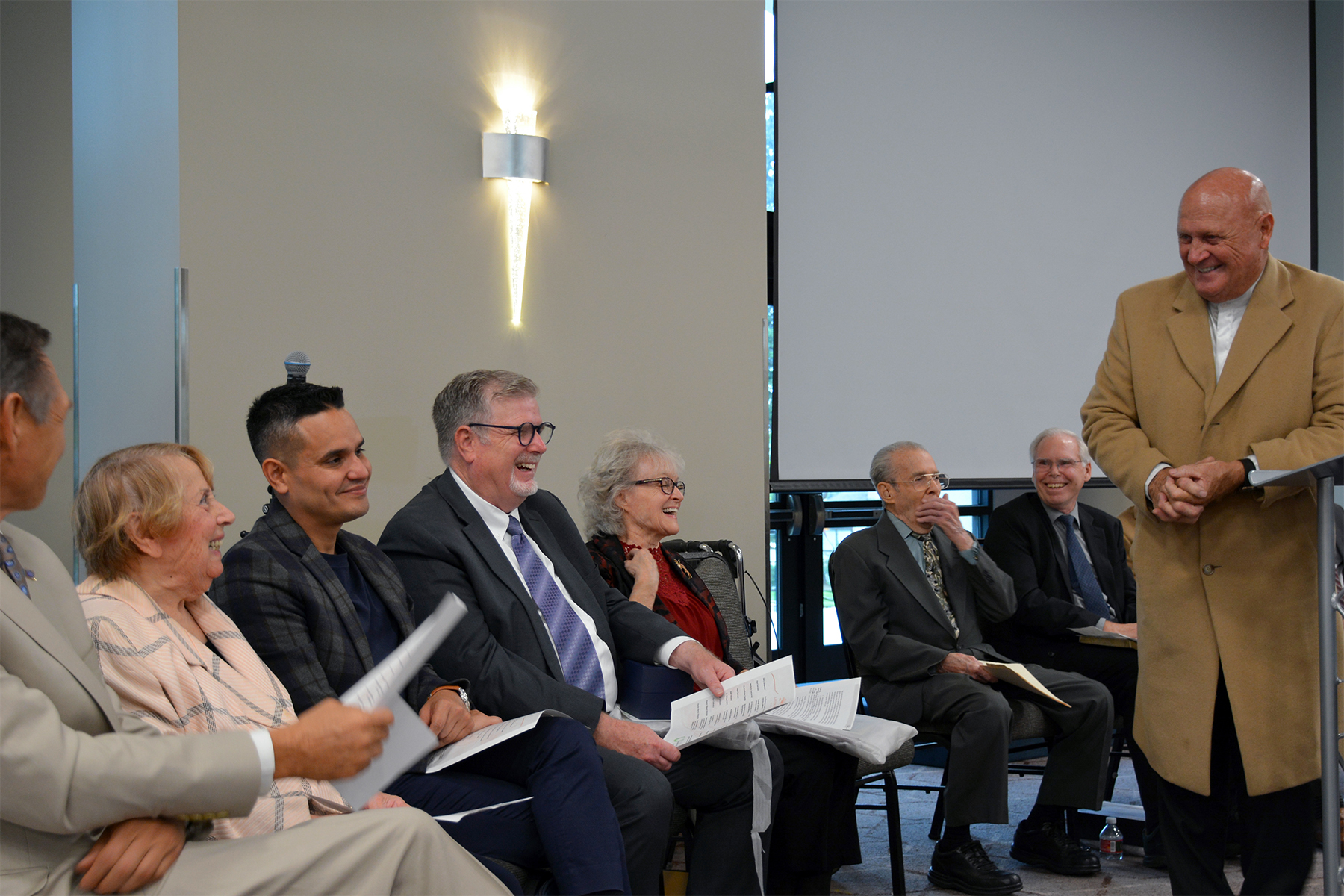 Gary Carpenter (right), co-chair of the Literature Ministry (LM), shares a light-hearted moment at the dedication service with several stakeholders.