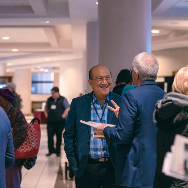 Friends share a laugh in the exhibit hall of the North American Division's Adventist Ministries Convention.