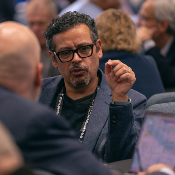 Two men in deep discussion at a conference.