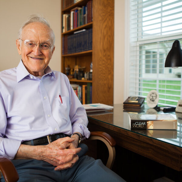Jack J Blanco, elder caucasian white male, sitting at desk with The Clear Word Bible paraphrase. He is author of book.