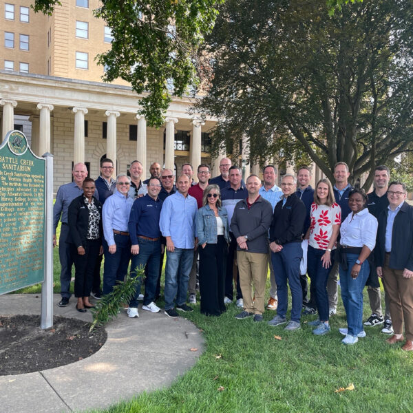 Group of men and women standing outside of the Battle Creek Sanitarium
