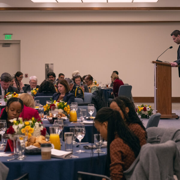 Prayer breakfast attendees bow their heads during one of several prayers