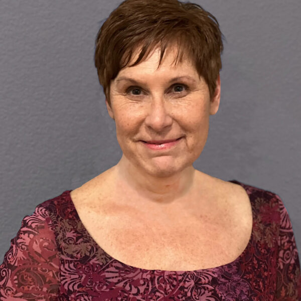 A professional headshot of a woman