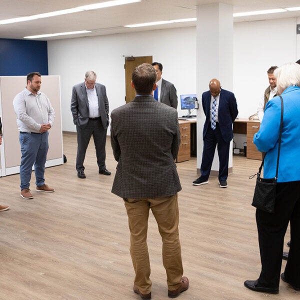 Adventist Connect group prayers at the new office on Walla Walla University campus, circle of people varying ages pray