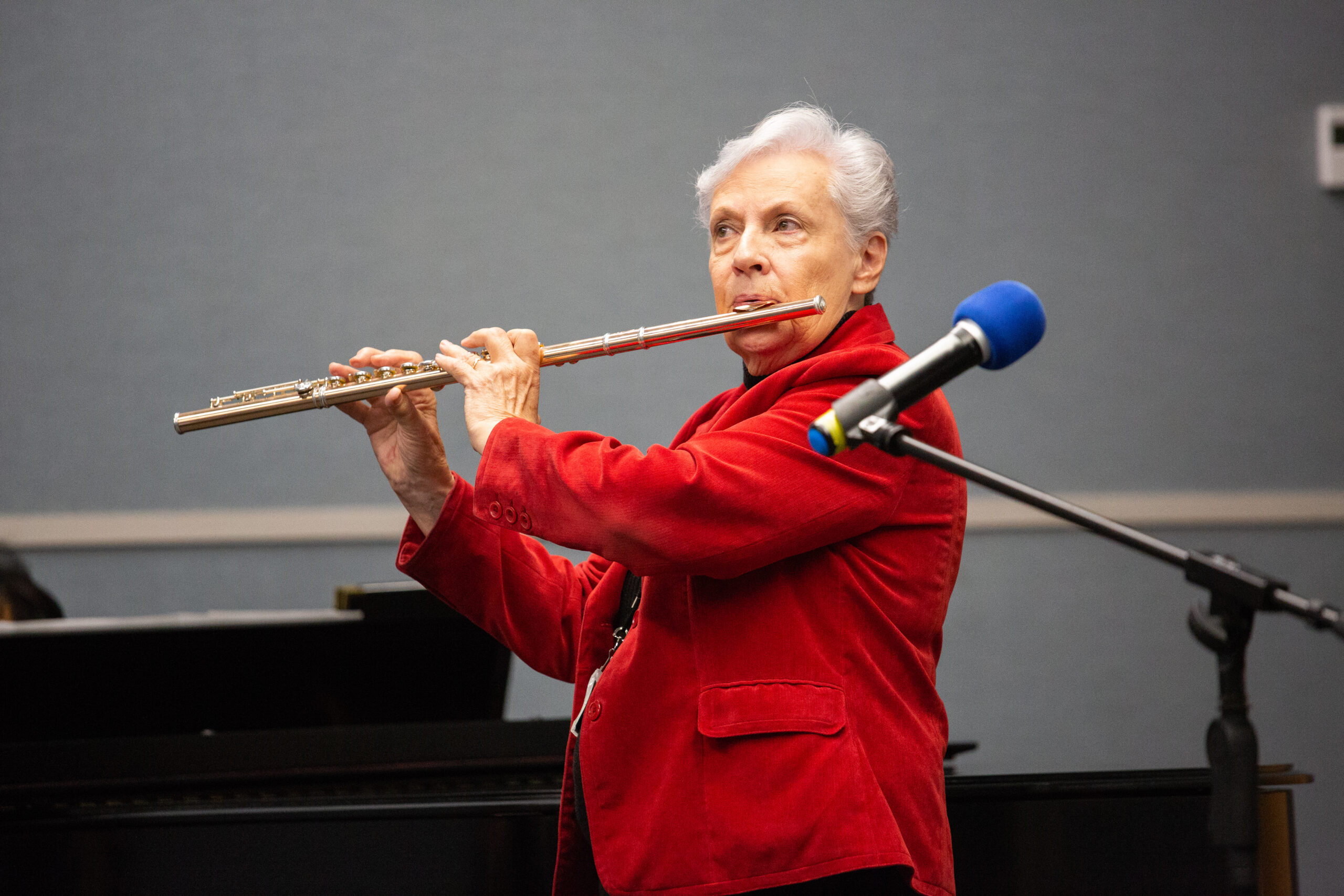 Lilya Wagner, director of PSI, plays her flute for the worship service on National Philanthropy Awareness Day.