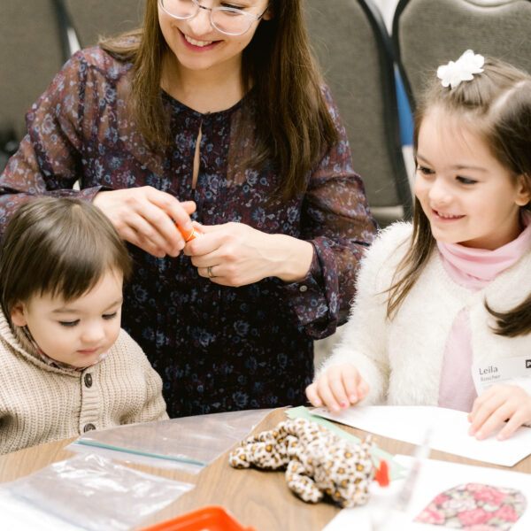 Mother and two toddler children at Sabbath School