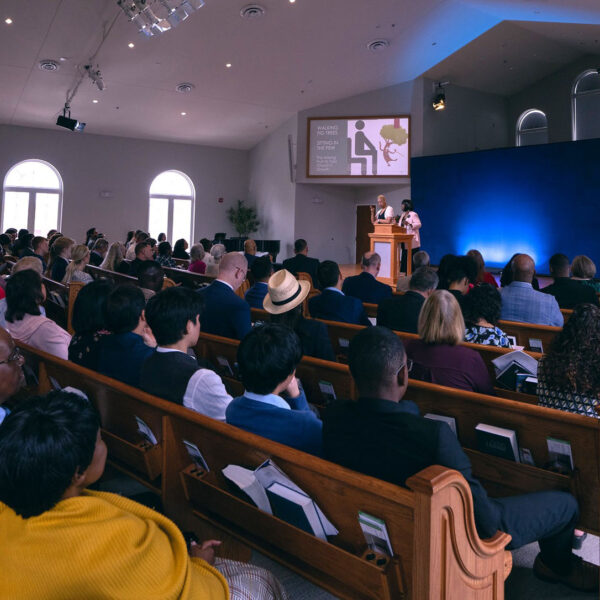Photo of a church congregation watching a presentation about supporting members with disabilities.