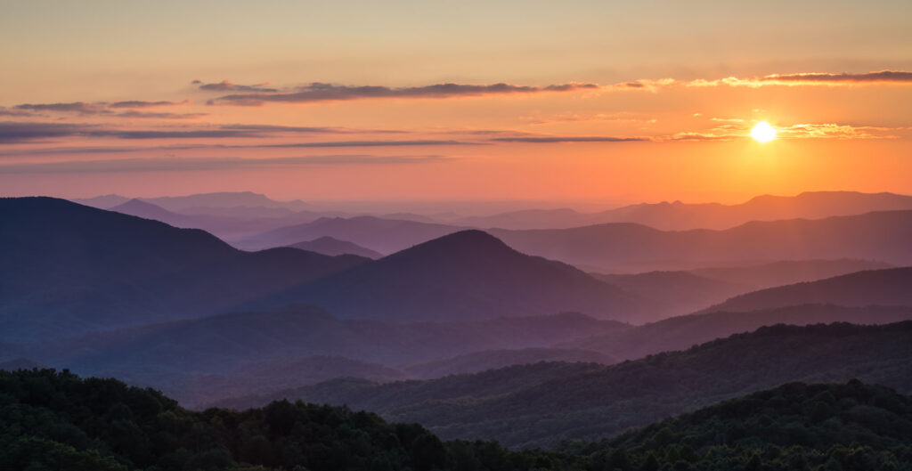 Sunset over the Appalachian Mountains, the hills purple with the coming night