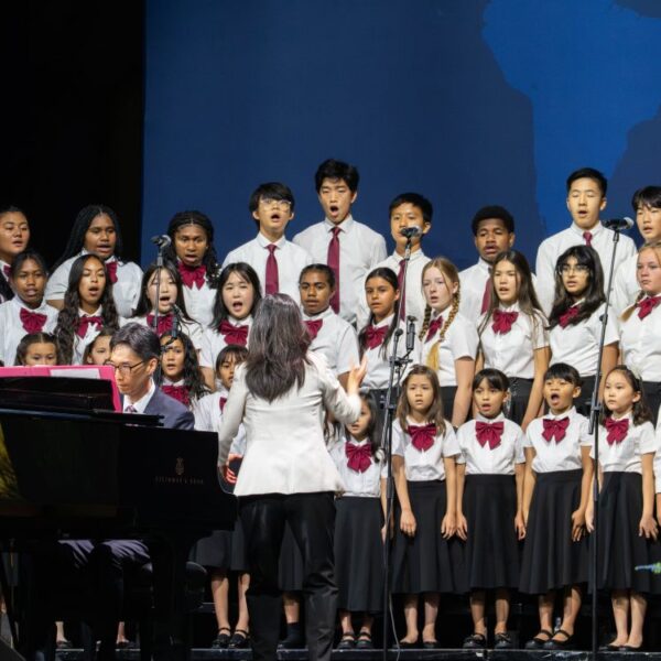 Children sing on the stage at the GC session.