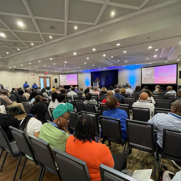 Wide shot of group at a conference