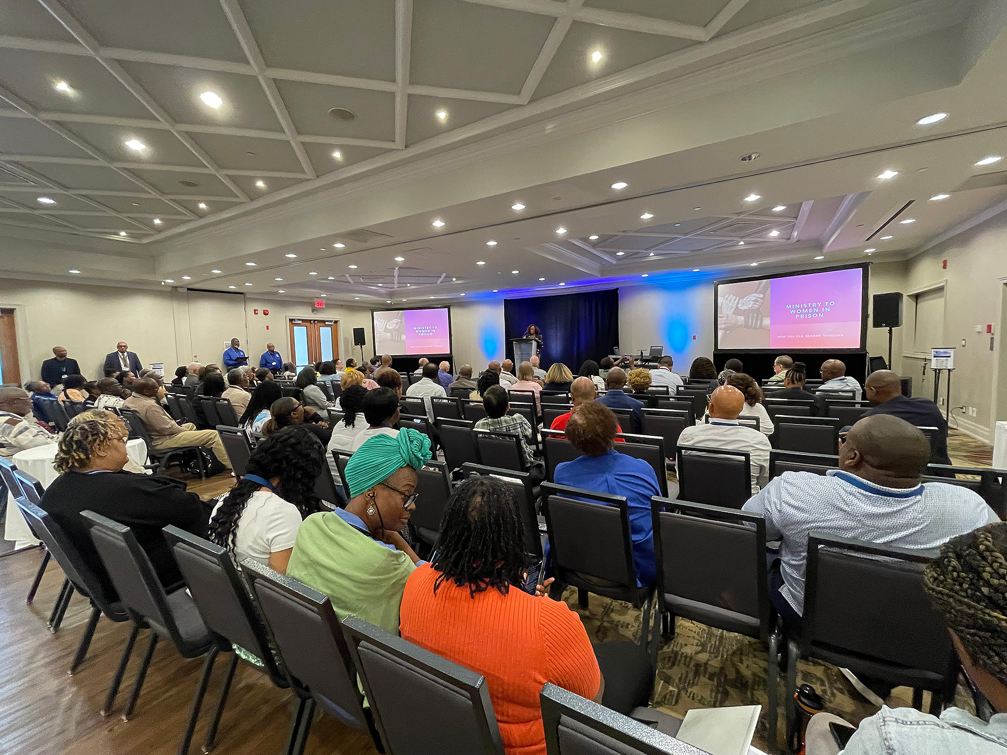 Wide shot of group at a conference