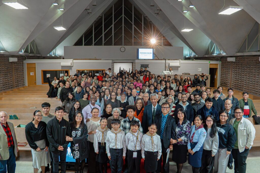 Photo of a congregation standing in the sanctuary.