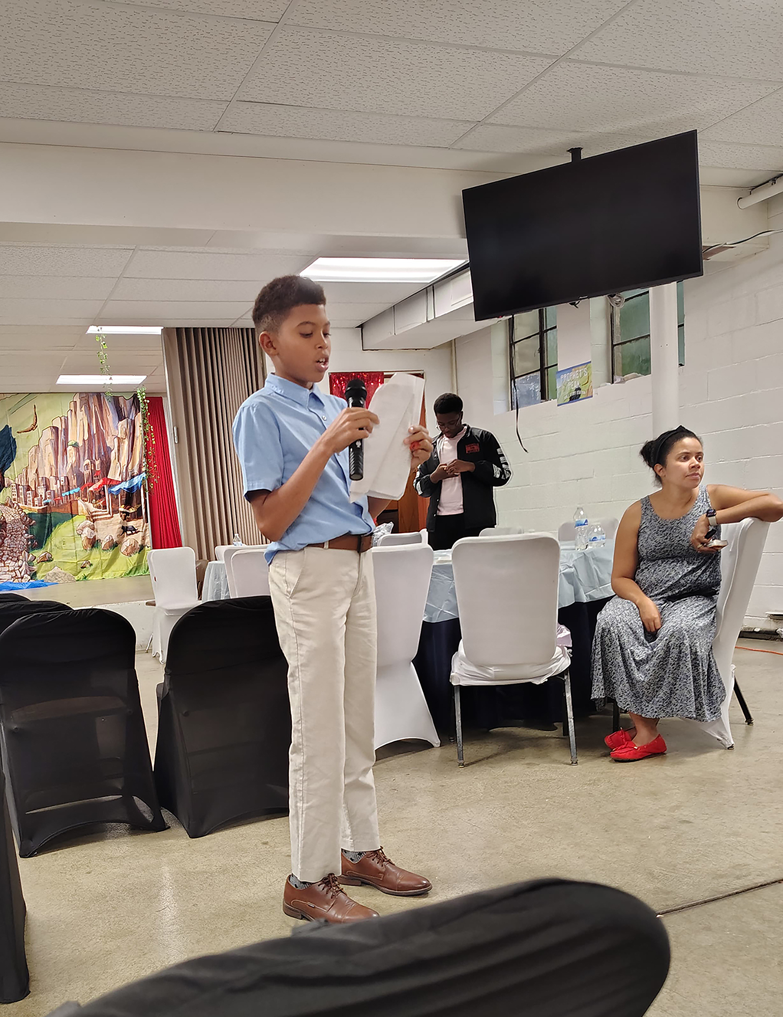 A young boy preaching during Vacation Bible School