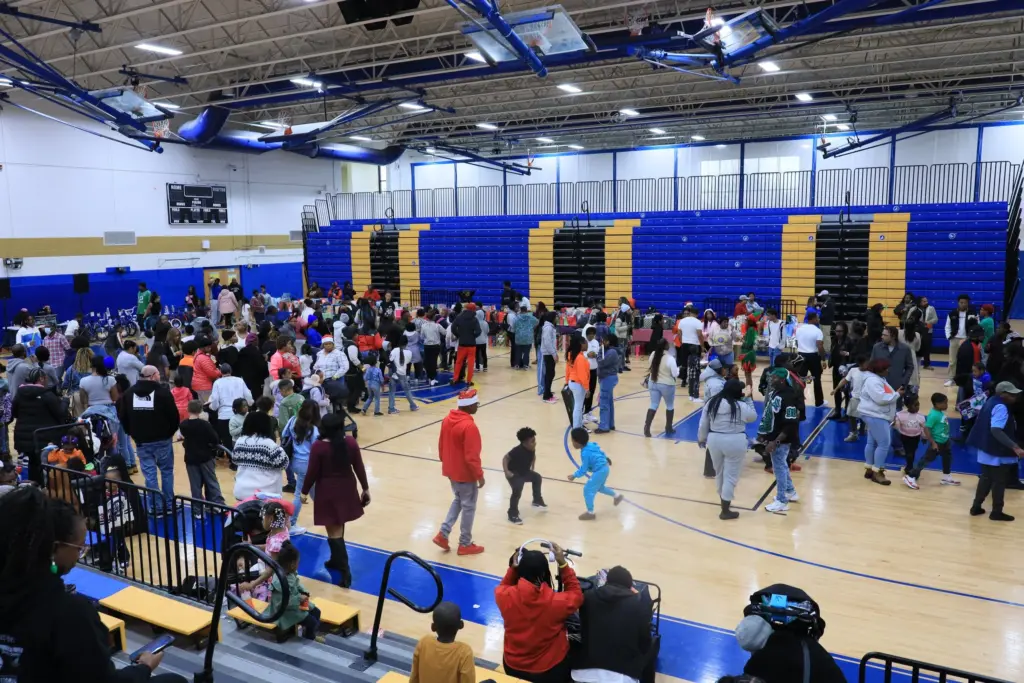 Various age groups are in a large room socializing with each other.