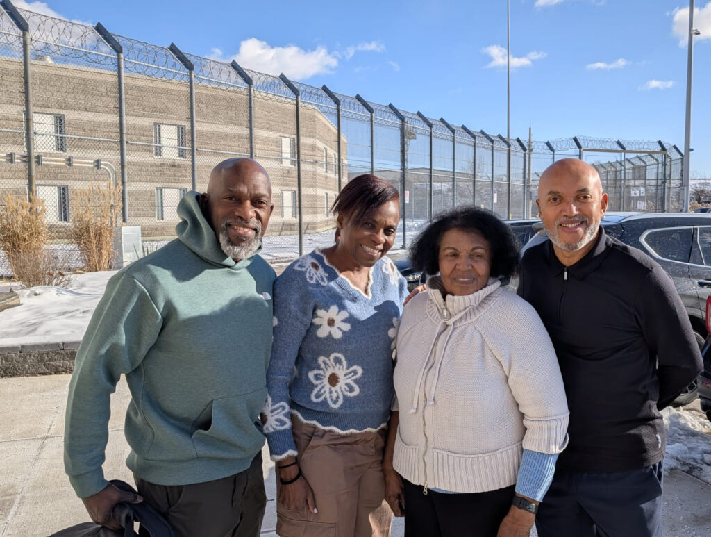 2 women and 2 men standing in front of a correctional facility.