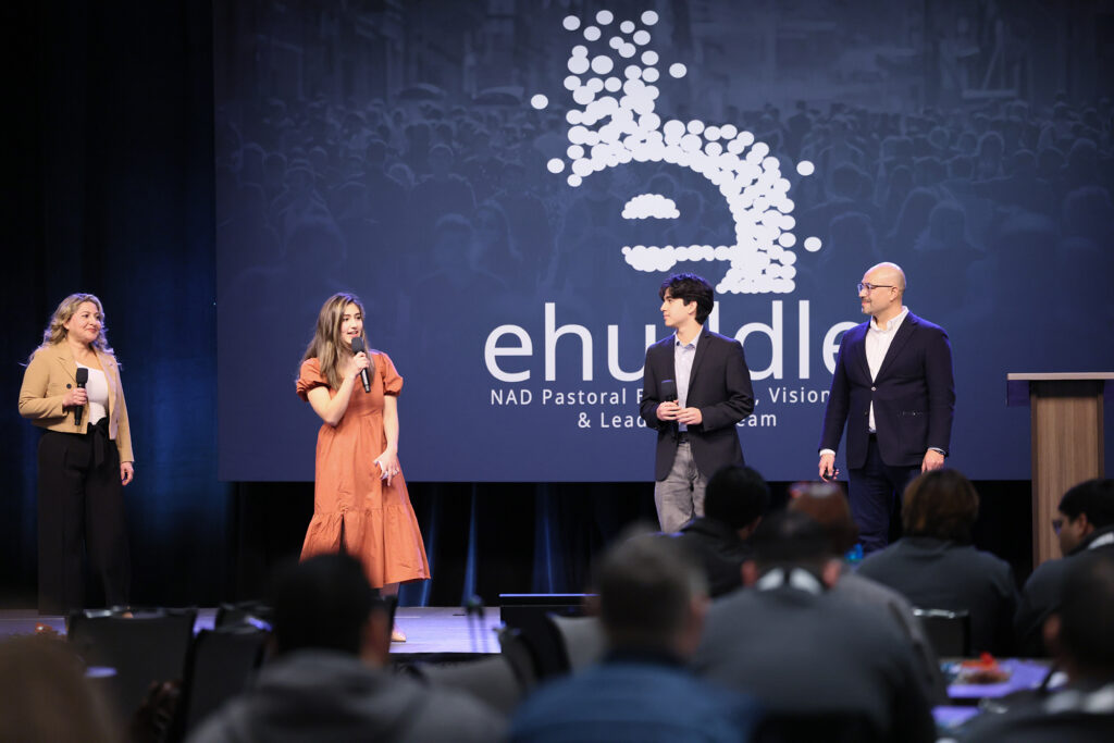 A family, mother, daughter, father, son, speak on the eHuddle stage.