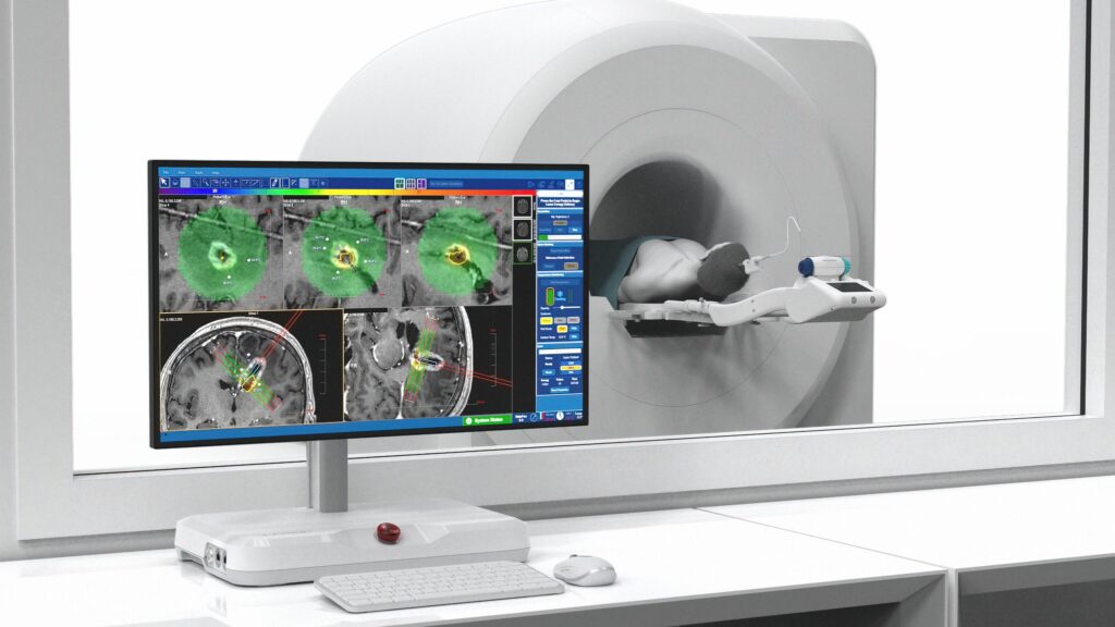 Picture of a monitor and a person in an MRI machine.