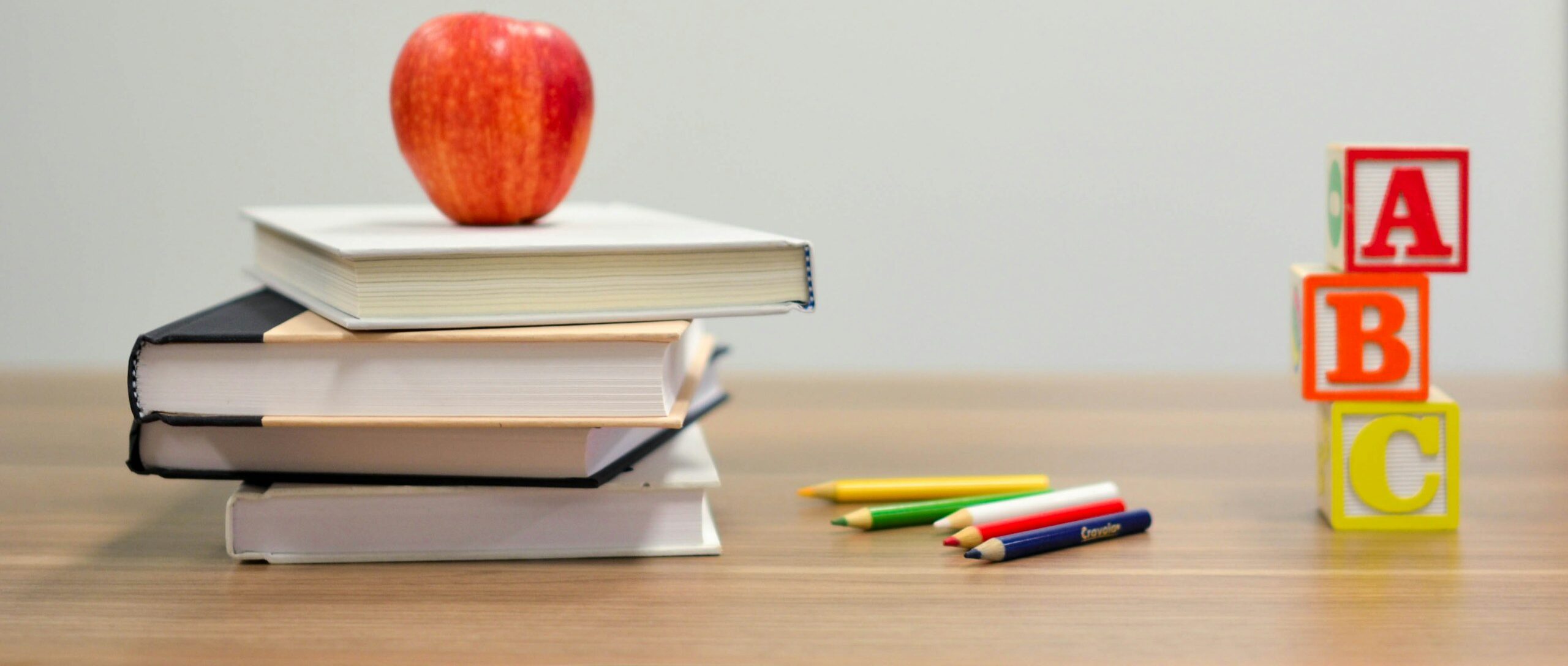 red apple fruit on four pyle books