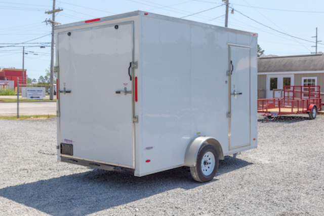 A picture of a FREEDOM 7X12SA enclosed trailer with a ramp door