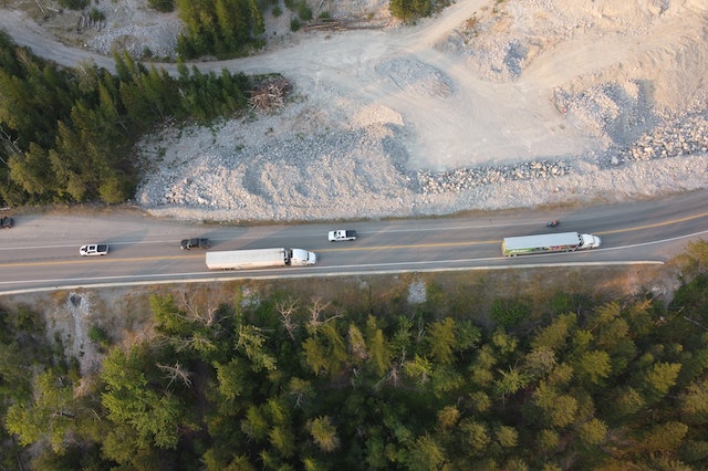 An overhead shot of two semi-trucks on a highway
