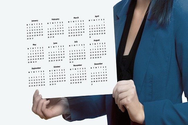 A person holding a yearly calendar