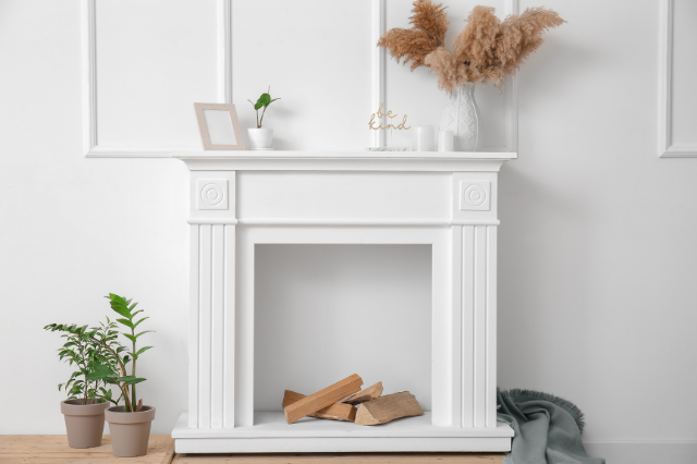 A white fireplace against a white wall 