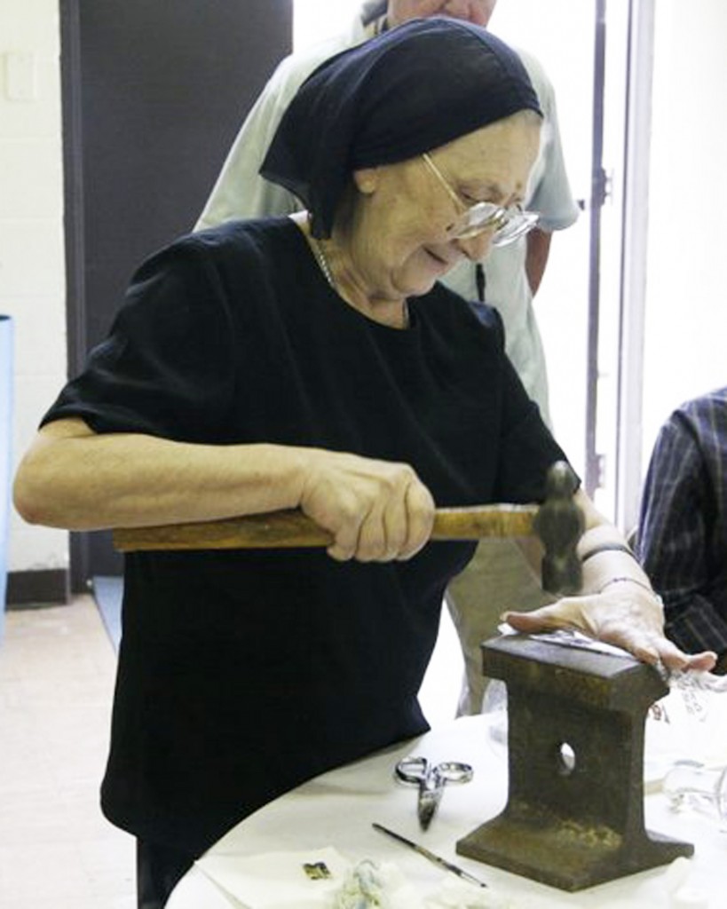 Ksenia crushing stones to make pigment