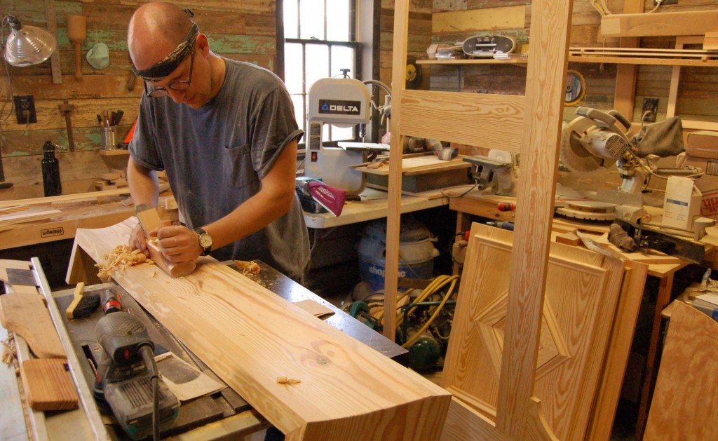 My assistant, Tom Podhrazsky, shaping the cornice from a 2x12 using a round-bottomed plane.