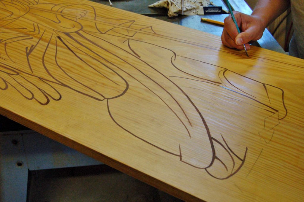 The paint is oil-based japan paint, applied over the shellac, and then top coated with a final coat of shellac.