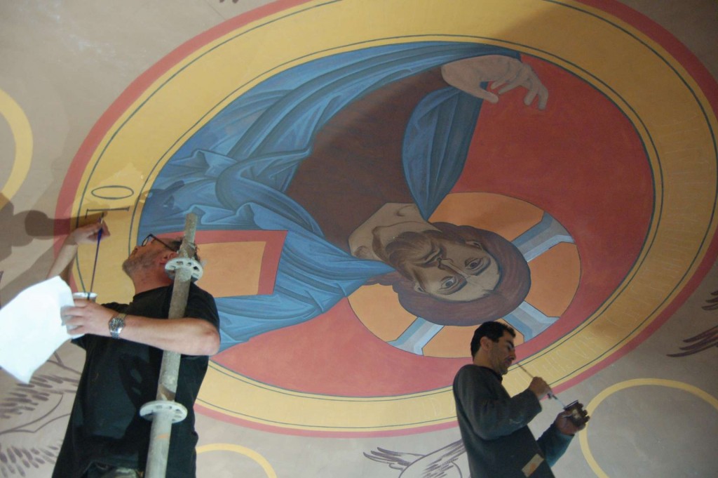 Dmitri painting the inscription around the Pantocrator, and Aleko painting the borders,