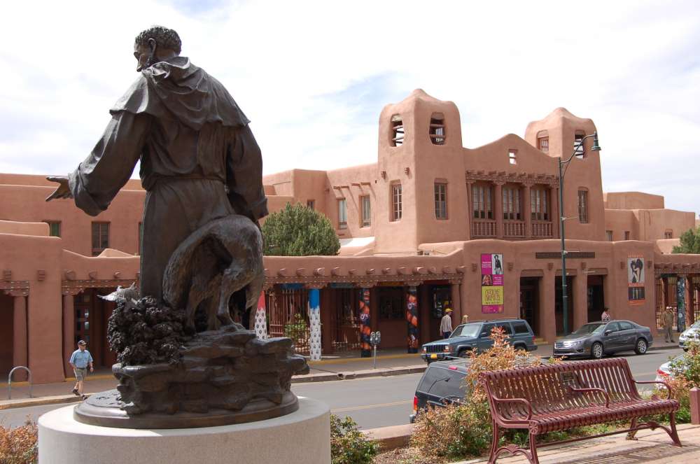 The architecture of downtown Santa Fe. In 1912 the city passed a law requiring all construction to be in the historic Pueblo/Mission style. This resulted in grand Pueblo-Revival buildings of the 1920s, such as this one, and has helped preserve the local building tradition to this day.
