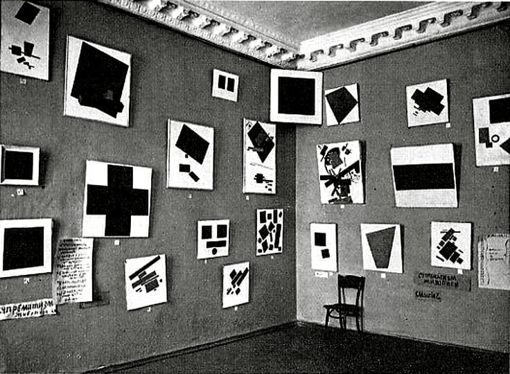 Kasimir Malevich, Gallery Instillation of The Last Futurist Exhibition, 0.10. The "red" corner of Suprematism.  Notice the  non-objective "icon", the Black Square, hung up high in the corner.
