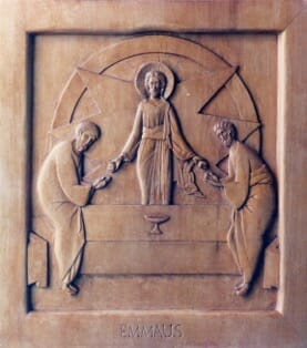 The Breaking of the Bread on the Road to Emmaus. Wood carving by the author.