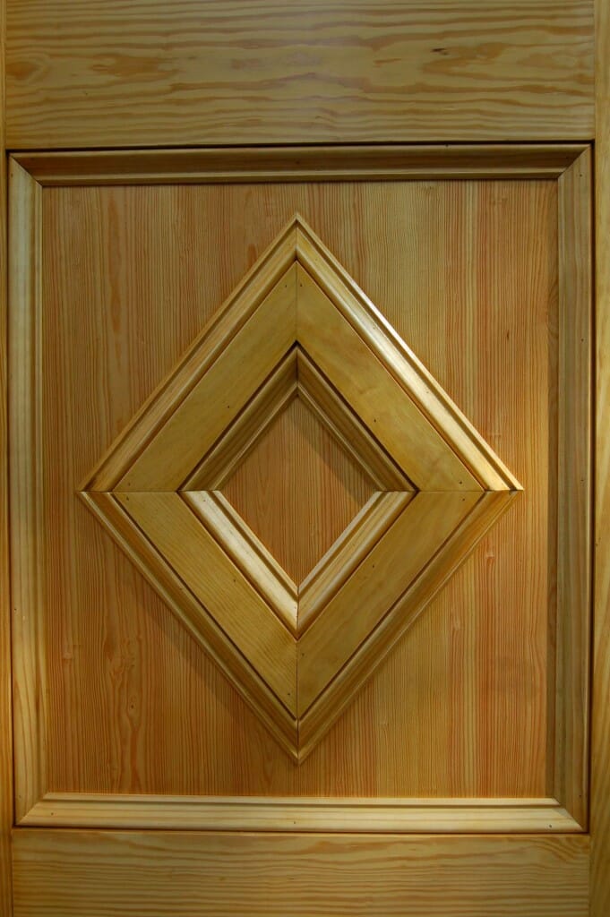 The bottom panels are made from 3/4" pine boards outlined with panel moulding (a.k.a. baseboard moulding).