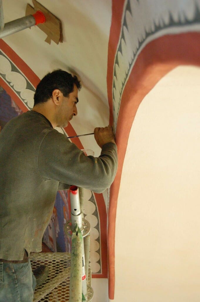 Aleko painting decorative borders on the pendentives.