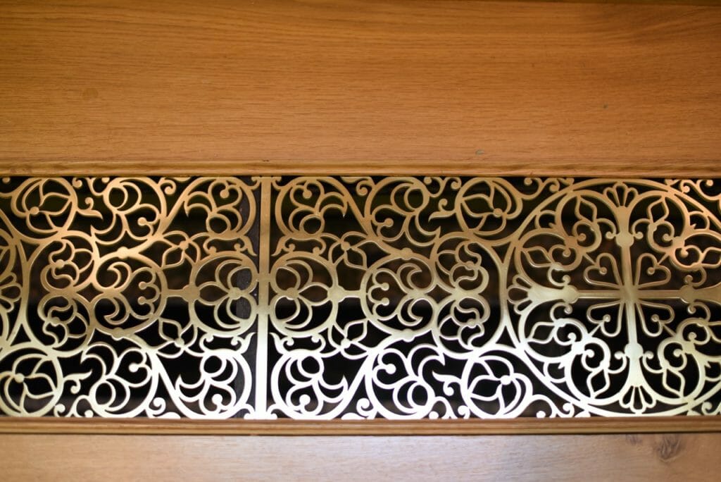 A radiator grill, water jet cut out from plate brass. Design by Aidan Hart.